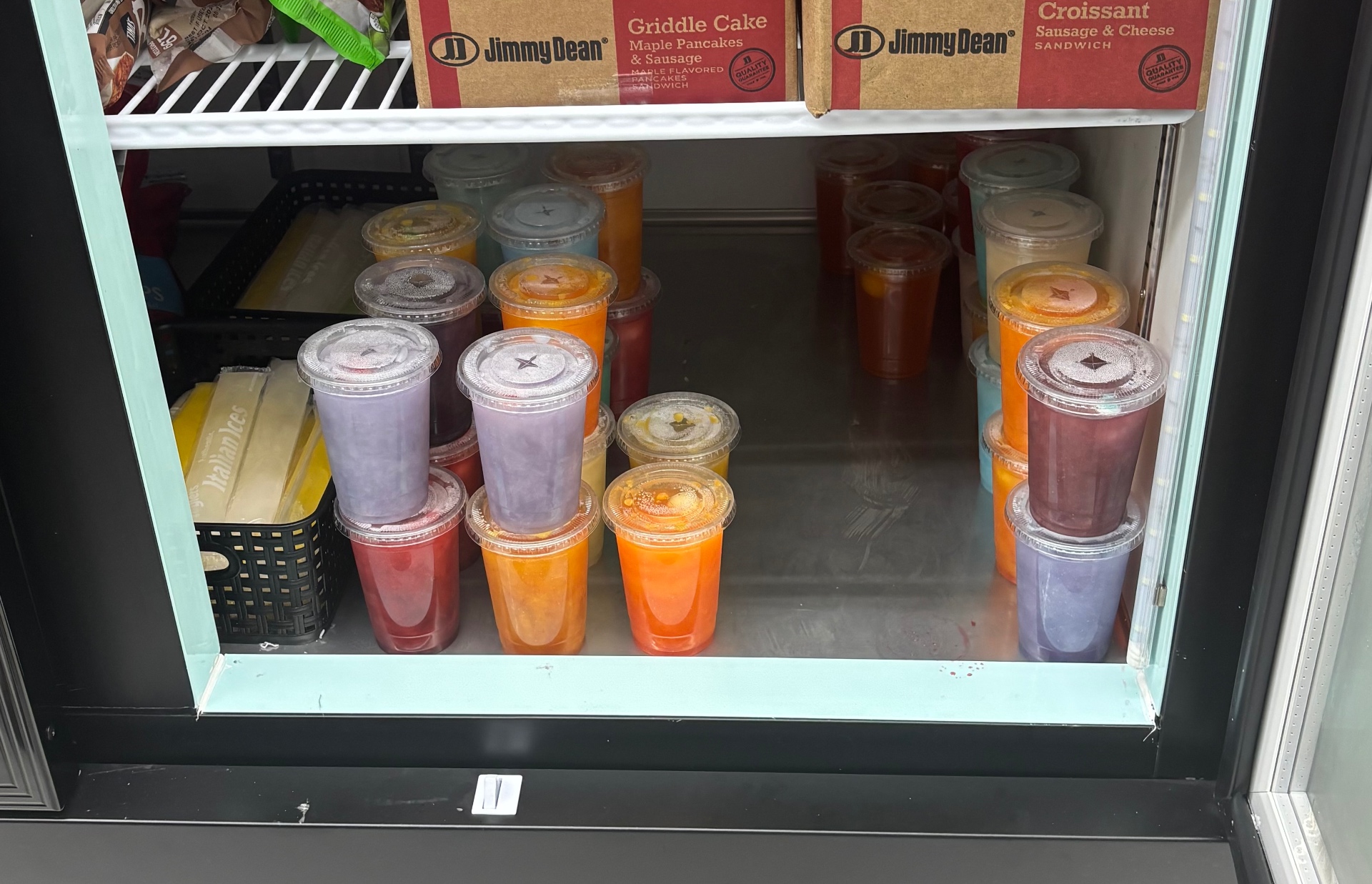 Freezer of Lilly Dilly's frozen cups in assorted flavors